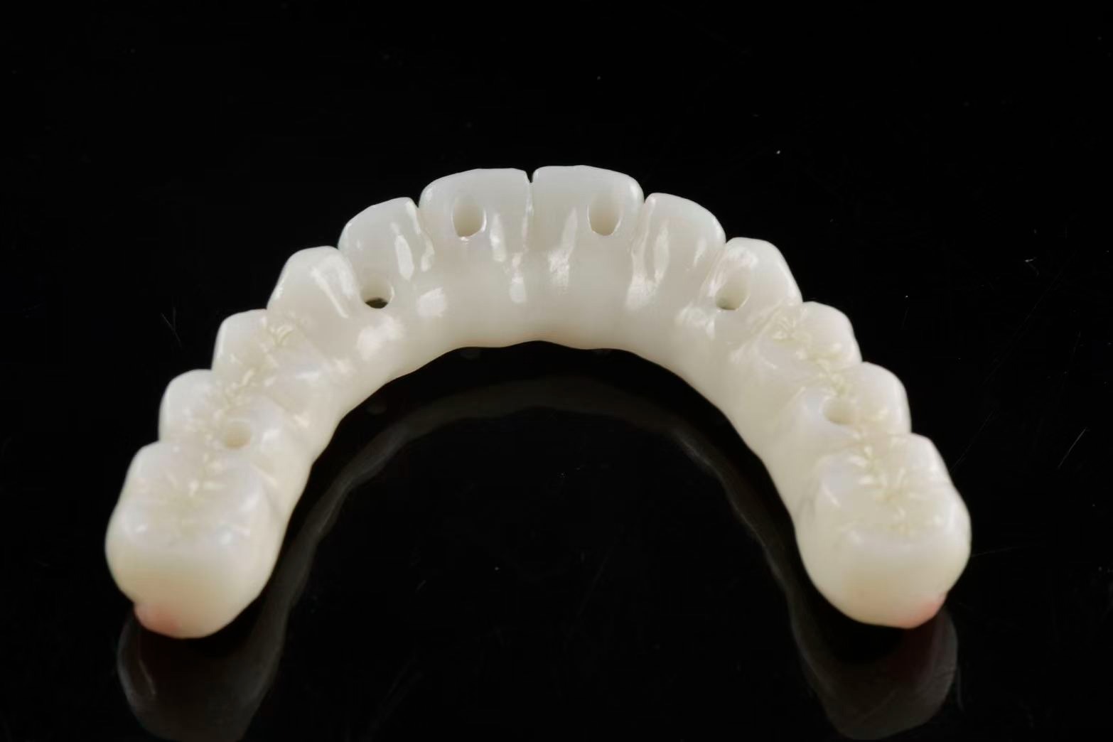 PMMA full-arch — intaglio view showing screw access holes